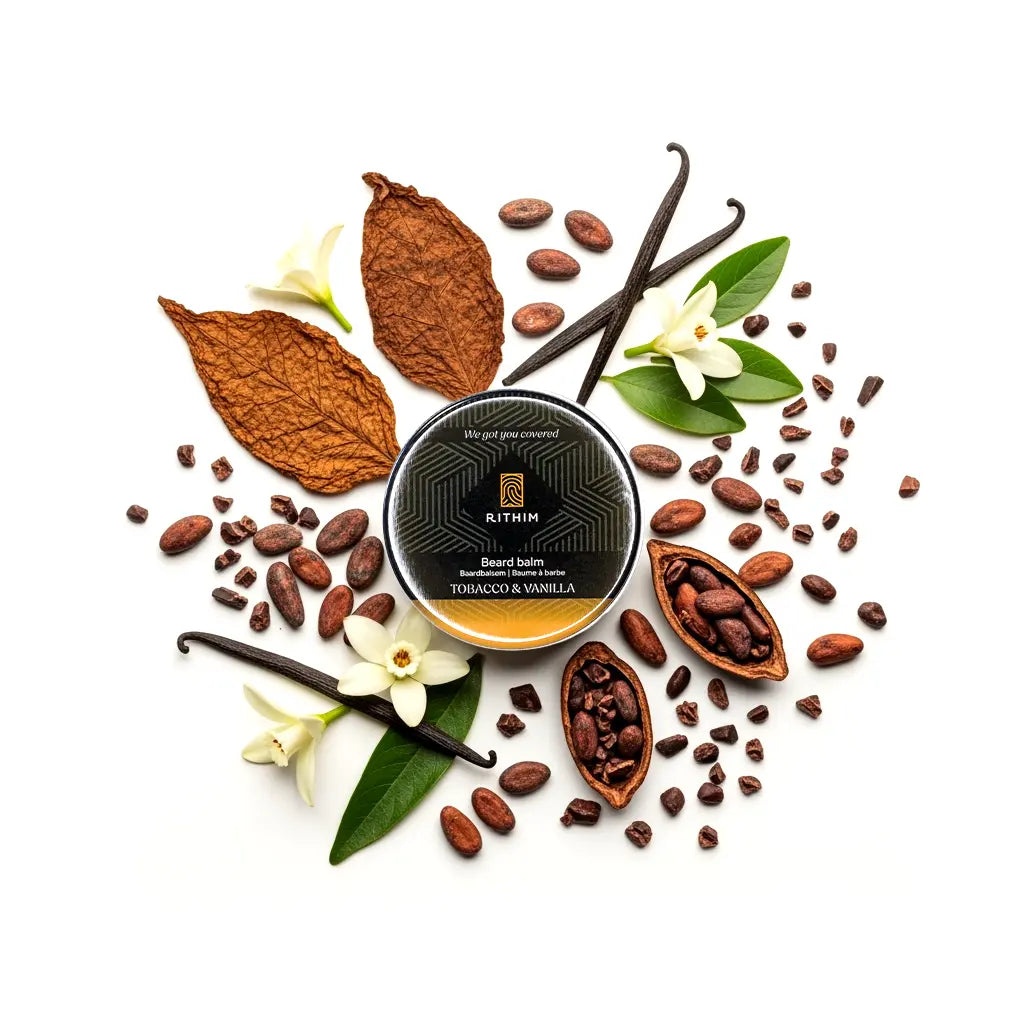 Rithim Tobacco Vanilla Beard balm container surrounded by tobacco leaves, vanilla beans, and vanilla flowers on a white background